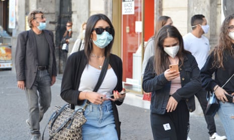People wearing face masks on the streets of Naples.