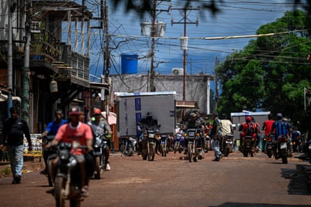 VENEZUELA-ENVIRONMENT-MINING-CRIMEA motorcyclist carries a bed base along a street in the town of Las Claritas, Bolivar state, Venezuela, on June 11, 2026. Venezuela, home to the world’s largest oil reserves, also has deposits of gold, diamonds, bauxite, coltan and rare earths, but much of its mining areas notably the 112,000 sq km Mining Arc located in remote regions far from major cities is controlled by armed gangs or guerrilla groups. (Photo by Federico PARRA / AFP via Getty Images)