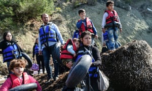 Syrian migrants wear life-jackets before boarding a dinghy to cross the Aegean Sea to the Greek island of Lesbos from the Ayvacik coast in Canakkale in 2016. 