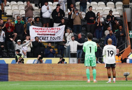 Supporters with a banner that reads ‘Manchester United: The World’s Biggest Football Club Ticket Touts’ as Senne Lammens and Bryan Mbeumo applaud fans after the Premier League match between Hull and Manchester United