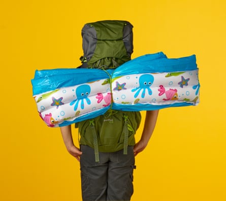 a person with a rucksack and an inflatable paddling pool