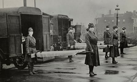 Mask-wearing women hold stretchers during the Spanish flu pandemic in St. Louis, Missouri, US, in October 1918.