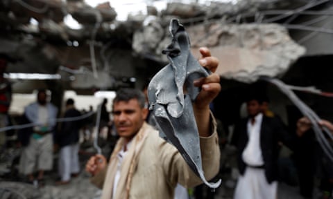 A man with a fragment of a missile found at the site of a Saudi-led air strike in Yemen in 2016. 