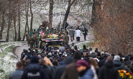 People attend the funeral of one of two victims of a missile blast that hit the Polish village of Przewodów.