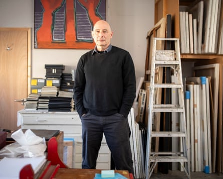 Ansel Krut surrounded by years of work in his packed stuido
