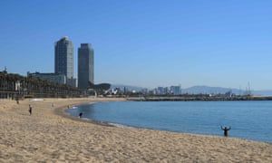 People walk at Barceloneta beach in Barcelona on 20 May 2020 during the hours that were reserved for the elderly.