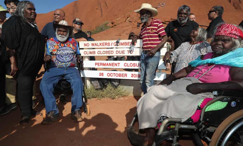 Traditional owners of Uluru gather around the base of the climb after it was permanently closed.