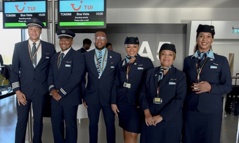 Six people standing in a row wearing flight uniforms qhiukiqrihuinv