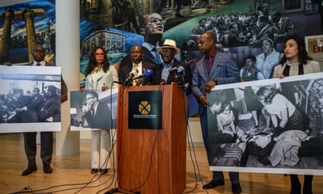 Mustafa Hassan, center, with civil rights attorney Ben Crump (third left) and Ilyasah Shabazz (second left) at a press conference in New York on Tuesday.