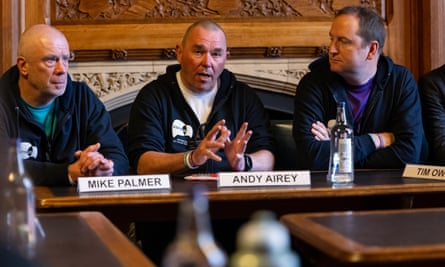 The three men speak at a meeting in parliament on 8 March 2023.