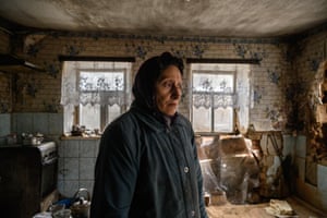 Tanya Los, 57, stands in her house near damage caused by a rocket. For several weeks, rockets have been raining down on this village located 70km from Zaporizhzhia