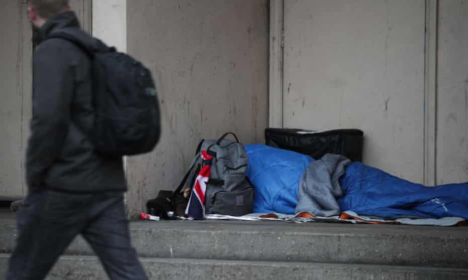 A homeless person sleeping rough in a doorway