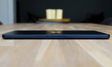 The MacBook Air M2 closed on a table showing the finger lip used to open the lid.
