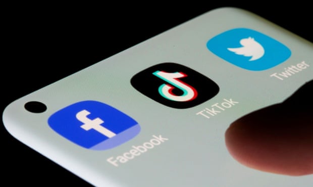 Facebook, TikTok and Twitter logos on a phone