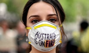 A demonstrator with a mask attends a climate protest rally in Sydney last Wednesday as bushfire smoke choked the city and the Australian government used the COP25 Madrid climate talks in Spain to push for dodgy accounting tricks to halve it climate effort.
