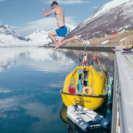 Guylee Simmonds jumps in for a swim next to his home in Norway