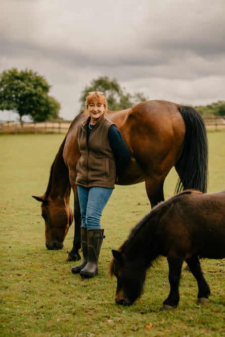 Commoner Gale Gould with commoner-owned horses in the field behind her home.