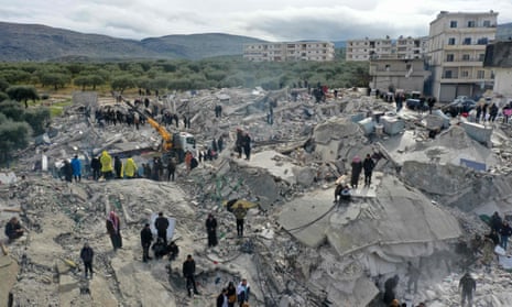 Searching for victims and survivors amid the rubble of collapsed buildings in Besnia.