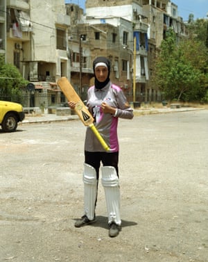 Amal, 16, pictured holding her bat, says the game has given her confidence