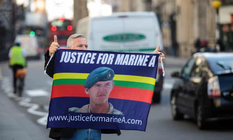 A supporter of Blackman holds up a banner outside the Royal Courts of Justice.