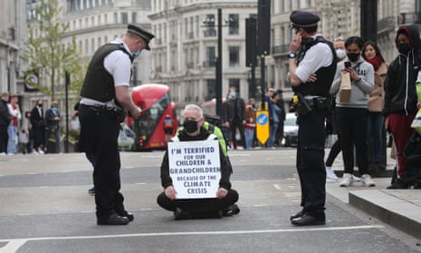 A man protests against the climate crisis in London.