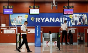 A man stands at a Ryanair check-in desk at Josep Tarradellas Barcelona-El Prat airport.