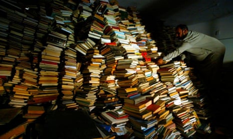 Iraqi assistant Imam Sheikh Mahmood Hachim sifts through the thousands of books in Baghdad’s Imam Alhaq Ali mosque in 2003. The books were looted from Iraq National Library after the fall of the capital, with some returned when clerics spoke out.