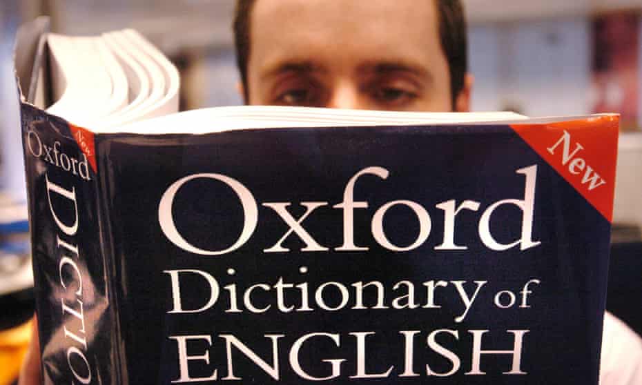 A man reads an Oxford English Dictionary
