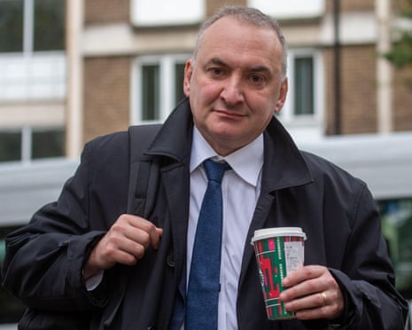 Chris Wormald carrying a coffee cup outdoors