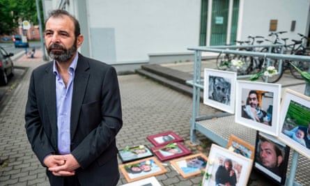 Bunni, with photographs of victims of the Syrian regime, outside the trial in Germany in June.