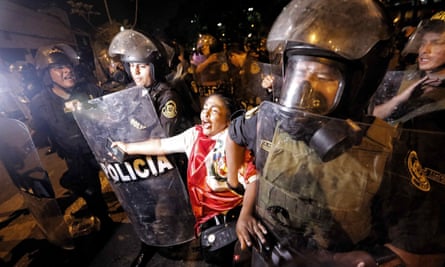 Police officers arrest a woman protesting against the government of Dina Boluarte in Lima, Peru.