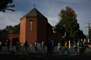 People line up at a voting centre at St Anthony’s Catholic church in Melbourne