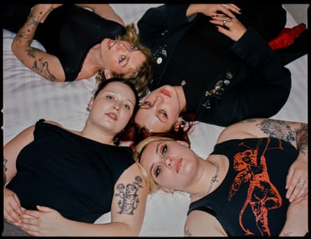 Teen Jesus and the Jean Teasers lying on a bed, heads meeting