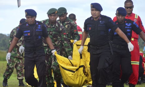 Indonesian soldiers and police carry a body bag containing the body of a victim of separatist attack in Nduga district in West Papua