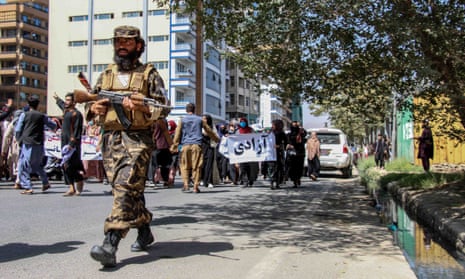 A Taliban fighter holding a gun during a protest in Kabul.