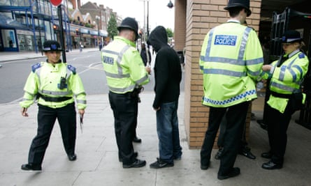 Police perform a stop and search in Harrow, London.