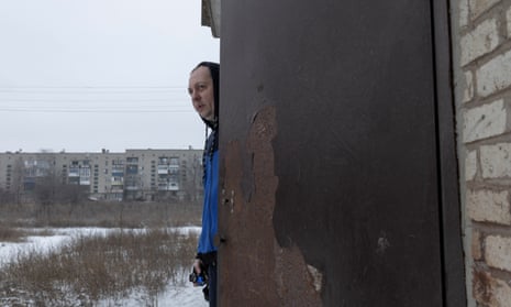 A resident looking out of his building in Chasiv Yar, Donetsk region.