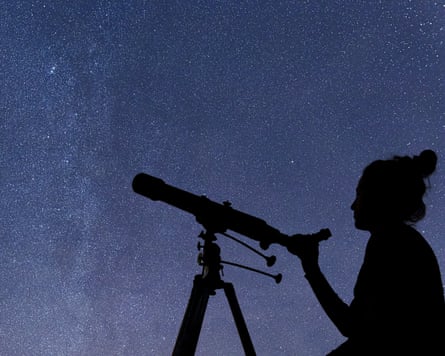 A woman with a telescope silhouetted against a starry sky.