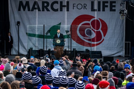 a man speaks to a crowd in front of a banner that reads ‘march for life’