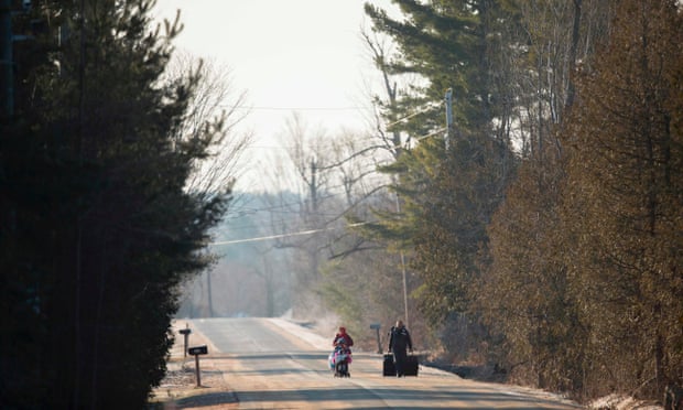 A family of four from Pakistan walk down Roxham Road in Champlain, New York, towards the US-Canada border on 28 February 2017.