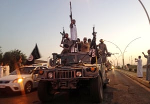 Islamic State parade in an armoured vehicle down a main street in Mosul.