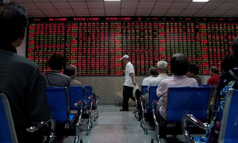 Investors look at an electronic board showing stock information at a brokerage house in Shanghai, China, today.