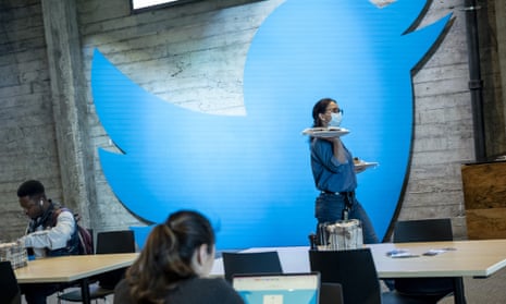 An employee carries plates of food at Twitter headquarters in San Francisco, California.