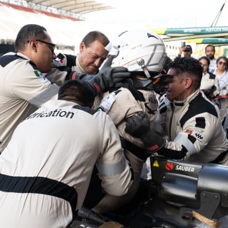 The extrication team carry out a rehearsal to remove a driver from a car, while the supporting firefighters and medical staff observe at the Mexican Grand Prix.