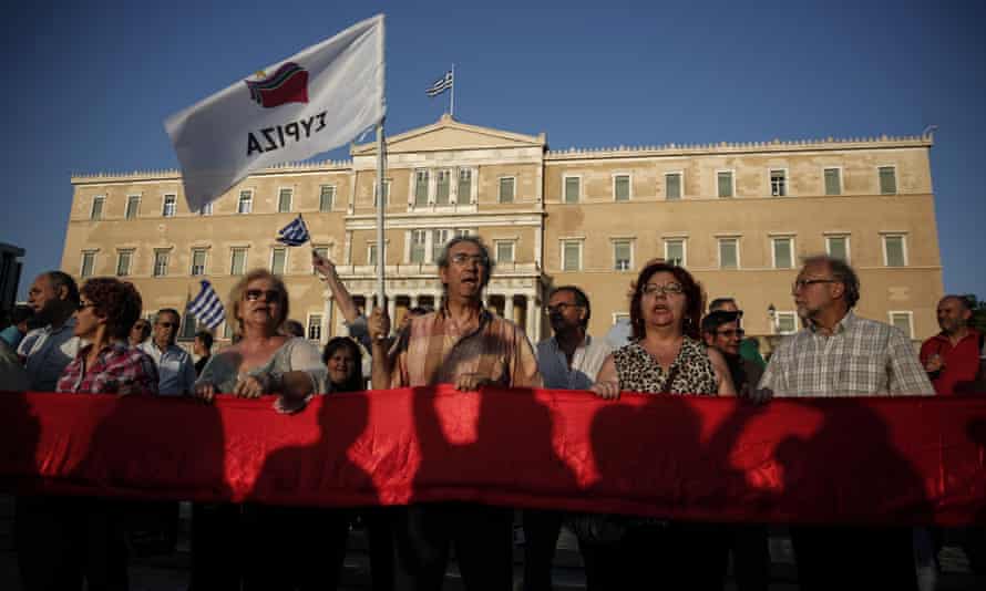 Supporters of the Greek ruling Syriza party shout slogans during an anti-austerity rally in front of the parliament in Athens, Greece, Wednesday, June 17, 2015.