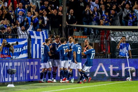 Fotis Ioannidis of Greece celebrates his team's first goal with his teammates.