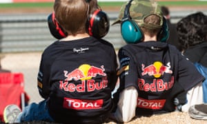 two young fans watching Formula One Red Bull jackets