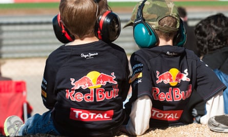 two young fans watching Formula One Red Bull jackets