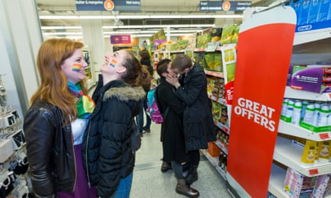 students with rainbow flags painted on their cheeks inside a sainsburys shop