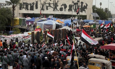 People holding national flags and chant religious slogans march in Tahrir Square